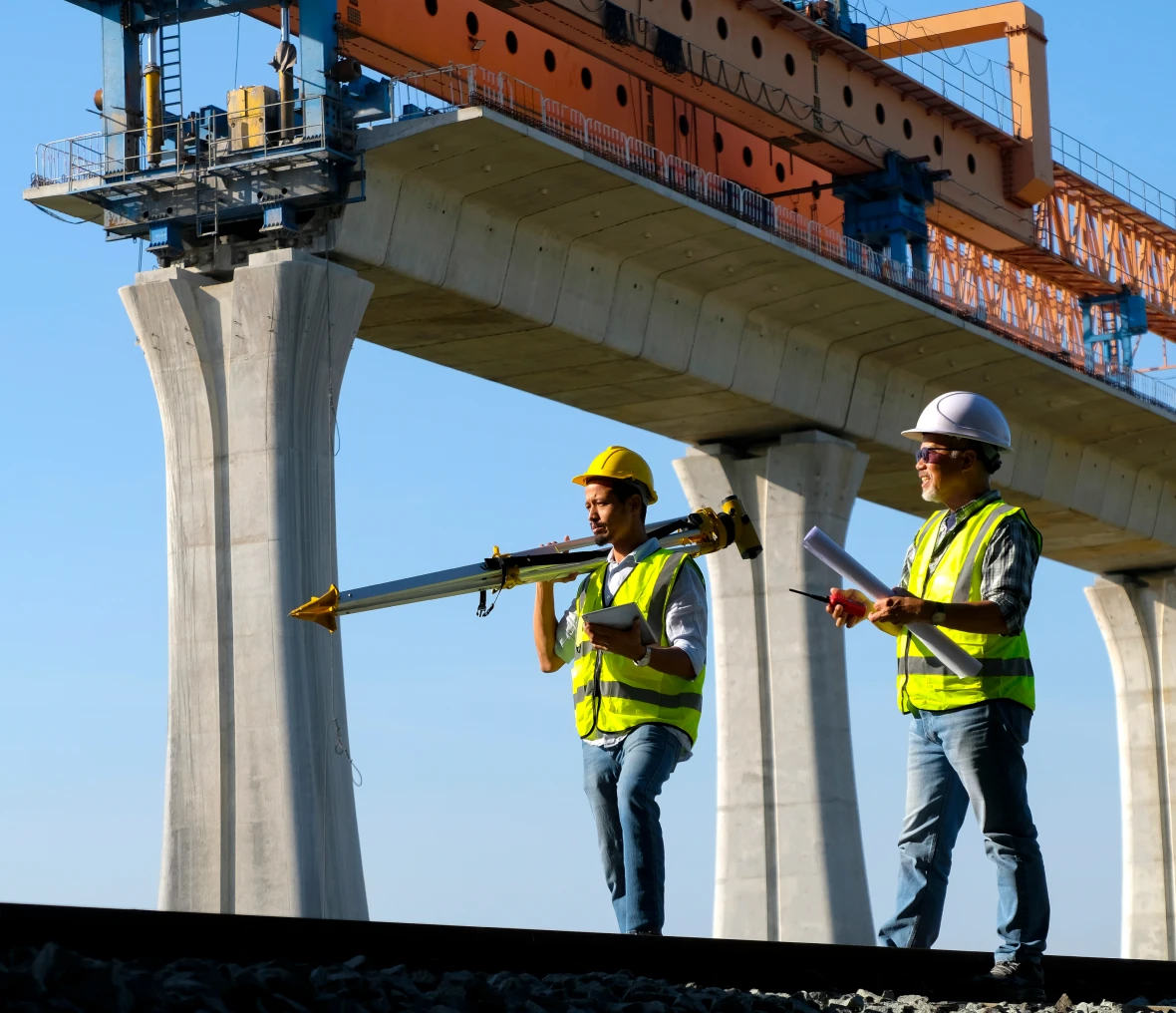 Engineers with equipment near bridge construction