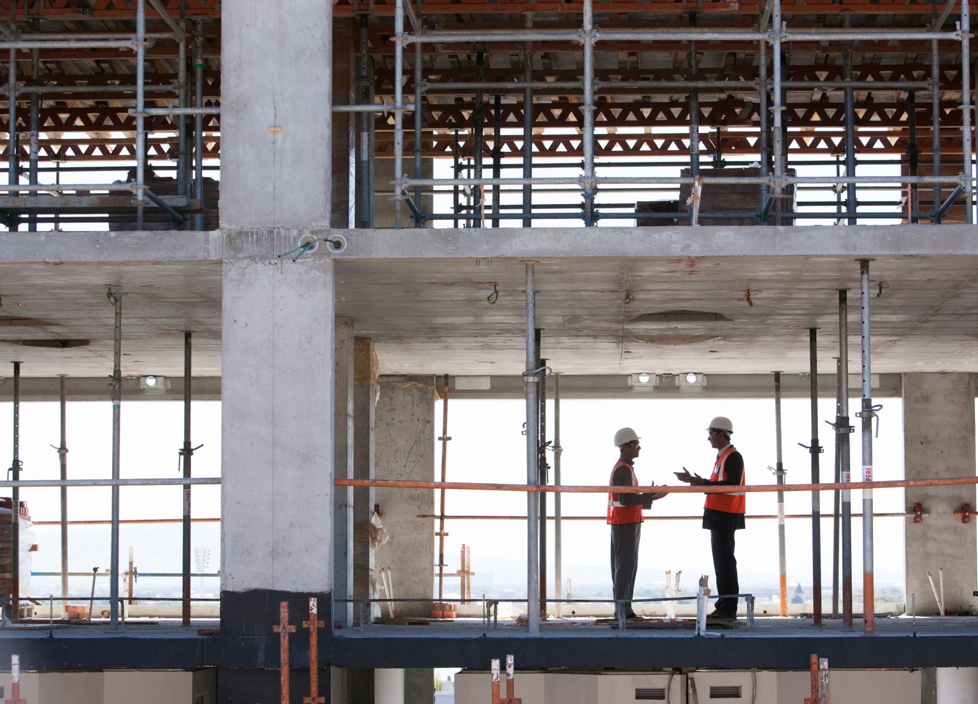 Construction workers discussing building plans